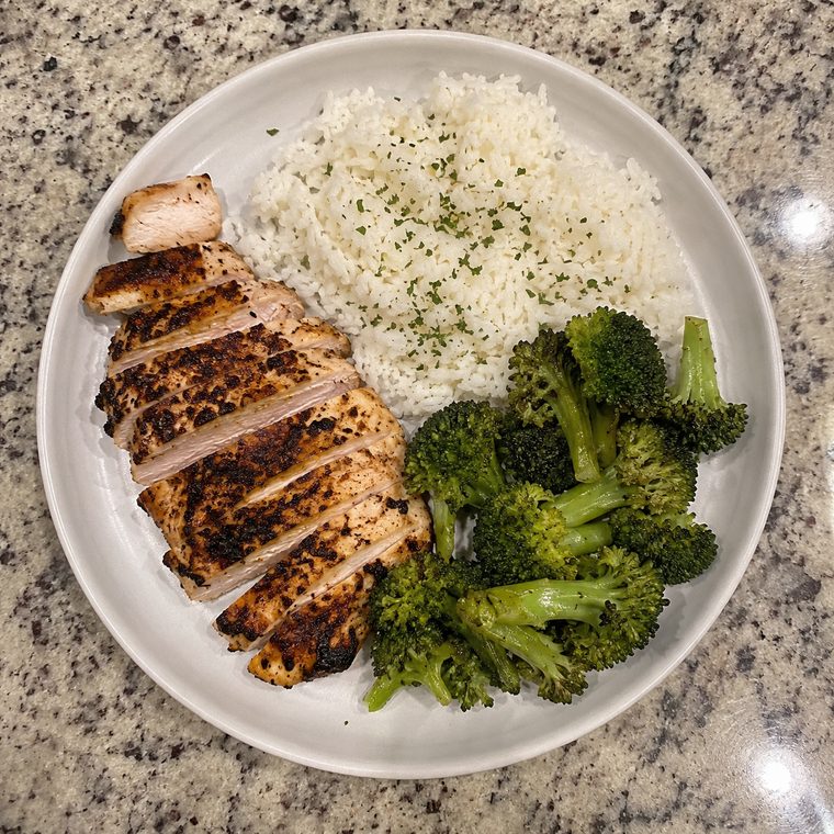 Plate of grilled chicken breast, white rice and broccoli